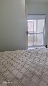 a bedroom with a bed and a large window at Flat Harmonia in Harmonia