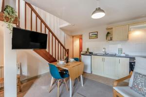 a living room with a small table and a kitchen at 2 Bed in Ingleton oc-n33612 in Ingleton 