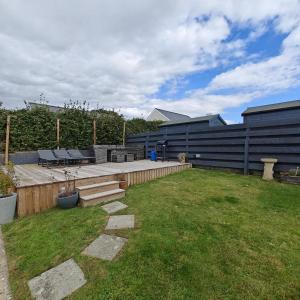 a backyard with a patio and a grass yard at 3 Bed in Pentlepoir oc-a33527 in Kilgetty