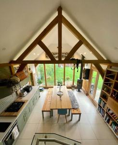 a kitchen with a table in the middle of a room at The Lodge, Smarden in Smarden