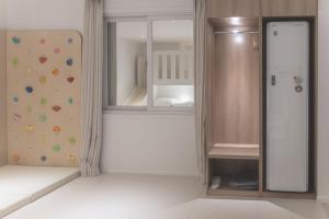 an empty room with a bed and a closet at 인별호텔 in Suncheon +43 photos