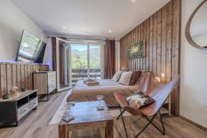 a bedroom with a large bed and a window at L'Ostalet suite luxe Jacuzzi in Ax-les-Thermes
