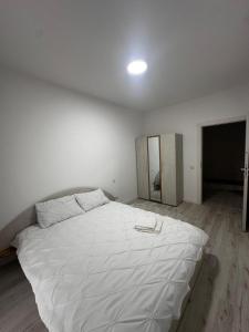 a bedroom with a large white bed in a room at Apartament panoramic in Bistriţa
