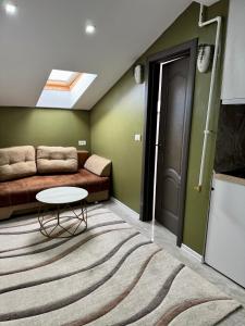 a living room with a couch and a table at Cozy Apartament with 2Rooms in Timişoara