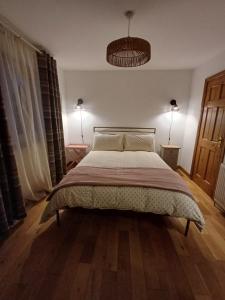 a bedroom with a large bed in a room at Dog friendly holiday home Acharacle sleeps 6 in Acharacle