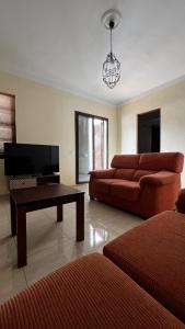 Una sala de estar con un sofá y una mesa de café. en CHC - Apartamento Los Topetes, en Buenavista del Norte