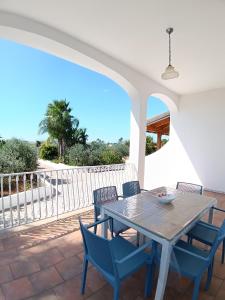a table and chairs on a patio with a view at Villa Mele in Lido Marini