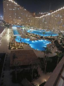a view of the pool at a hotel at night at Porto Sokhna Pyramids Hotel Apartments in Ain Sokhna