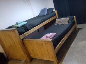 two wooden beds sitting next to each other at Departamento Pablo's in Río Colorado