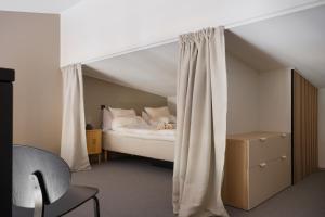 a bedroom with a bed with a canopy at Auroras by Kaltios, Gielas, Ski-in Ski-out, Mountain view in Kittilä