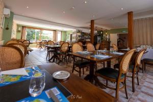 a dining room with wooden tables and chairs at Les Ambassadeurs Logis Hotels et Restaurant in Souillac