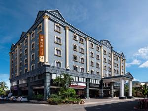 a large building with a sign on the side of it at GUIDE HOTEL Kenting Resort in Hengchun South Gate
