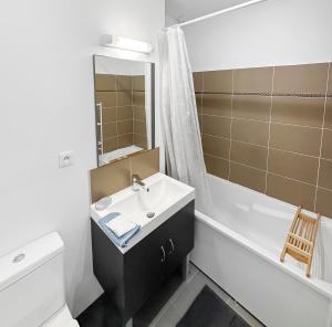 a bathroom with a sink and a tub and a toilet at Un Temps Pour Nous - Downtown house near beach in Cucq +24 photos