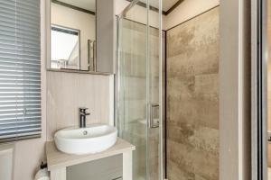 a bathroom with a sink and a glass shower at 2 Bed in Hendra Croft oc-h32360 in Cubert