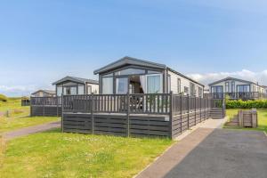 a row of modular homes in a field of grass at 2 Bed in Hendra Croft oc-h32360 in Cubert