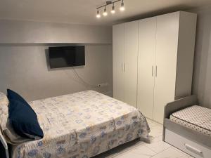 a bedroom with a bed and a cabinet and a television at A Casa Di Laura B&B Apartments in Campagna