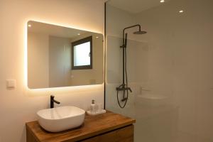 a bathroom with a white sink and a mirror at Villa Joy, moderna e sofisticada in Funchal +19 photos