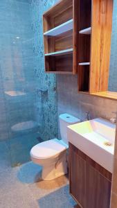 a bathroom with a toilet and a sink and a shower at Appartement Aéroport Sunset Marrakech in Marrakesh