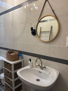 a bathroom with a sink and a mirror on the wall at El Mirador del Asno in El Bosque +39 photos