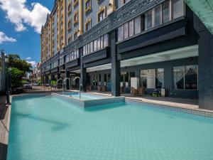 a large swimming pool in front of a building at GUIDE HOTEL Kenting Resort in Hengchun South Gate