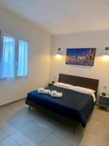 a bedroom with a bed with two towels on it at RavennaMia in Ravenna