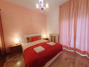 a bedroom with a bed with two towels on it at Fiori e Frutti Sunshine Home in Almese