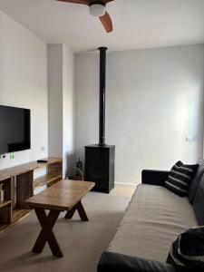 a living room with a couch and a wood stove at El Mirador del Asno in El Bosque
