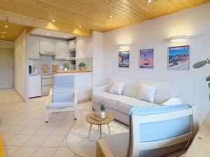 a living room with a couch and a table at Cocon moderne vue pistes - Balcon sud- télécabine 160 m in Chamrousse