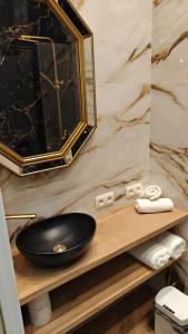Un baño con un lavabo negro y un espejo. en Hotel Leopold, en Brujas 73 fotos más