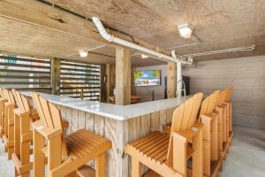 a bar in a room with wooden chairs at 2064 - Just Ducky II in Poteskeet Village