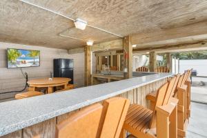 a bar with wooden chairs and a counter top at 2064 - Just Ducky II in Poteskeet Village