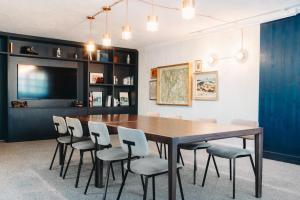 a dining room with a wooden table and chairs at Hôtel des 2 Gares in Saint-Gervais-les-Bains +91 photos