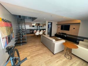 a living room with a couch and a table at Flats no Hotel Mercure Belém Boulevard in Belém