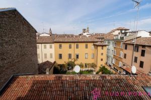 a view of a city from the roofs of buildings at Tetti di Parma in Parma