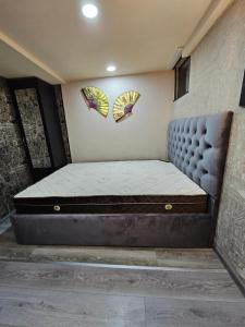 a bed in a room with two kites on the wall at different house in Tbilisi City