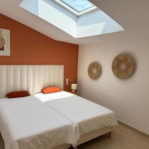 two beds in a bedroom with a skylight at villa NOESIS in Grosseto-Prugna +37 photos