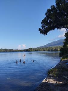 a group of people swimming in a lake at TiKi Hostel Island Ometepe in Rivas +7 photos