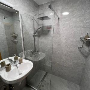 a bathroom with a sink and a glass shower at Lucky Home Timisoara 1 in Timişoara