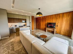a living room with a couch and a table at CFC Casablanca - Luxury 1-Bedroom Apartment with Anfa Park View in Casablanca +9 photos