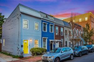 a blue house and cars parked on a street at - 5-Min Walk To Metro - Free Prking - Escape in Alexandria