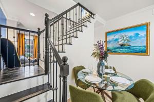 a dining room with a glass table and green chairs at - 5-Min Walk To Metro - Free Prking - Escape in Alexandria