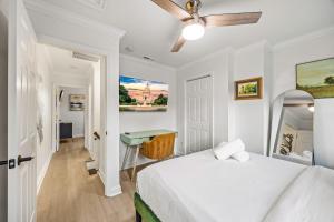 a white bedroom with a bed and a desk at - 5-Min Walk To Metro - Free Prking - Escape in Alexandria
