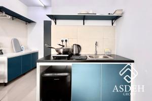 a kitchen with a sink and a stove top oven at Midlands City Broga Semenyih by ASDEH Suites in Semenyih