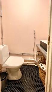 a bathroom with a white toilet in a room at Elegant Jugend city retreat 79m2 in Helsinki