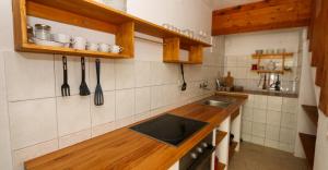 a kitchen with a sink and a counter with utensils at Kuća na plaži in Razvala +7 photos