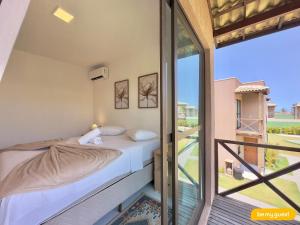 a bedroom with a bed and a balcony at Beachfront Duplex B por Be My Guest in Aquiraz +110 photos