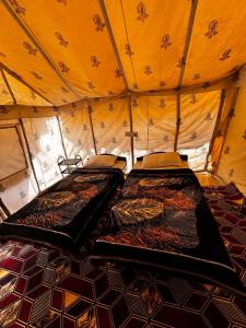 a room with two beds in a tent at Maha Kutch Rann Camp in Dhordo