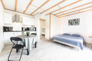 a bedroom with a table and a bed in a room at Le gite du prunus in Montamisé
