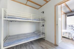 a room with two bunk beds in a room at Le gite du prunus in Montamisé