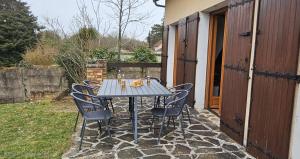 a blue table and chairs on a patio at La cherpée in Lhommaizé